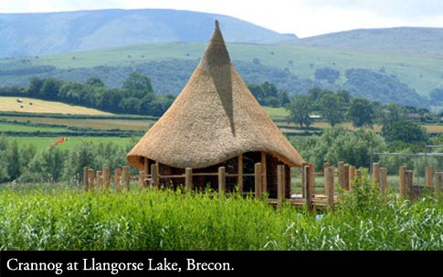 Thatched Crannog roundhouse at Llangorse Lake Brecon, Wales.